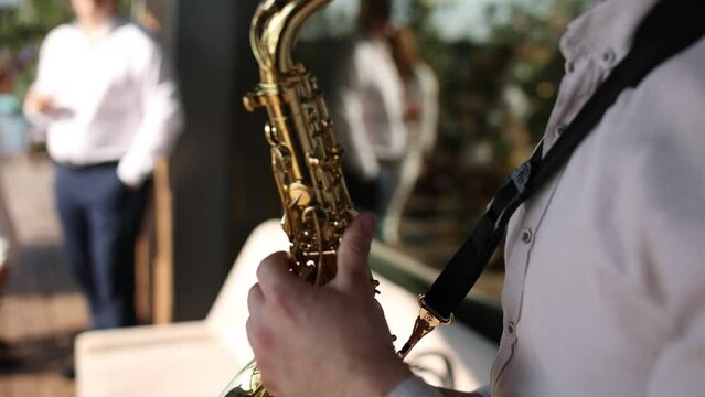 a man plays the saxophone on a holiday in a restaurant