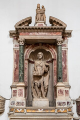 Fototapeta na wymiar Jesus Christ statue decorating marble altar carved in the wall inside catholic church in Napoli
