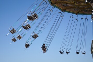 Teenage girl on chain swing carousel