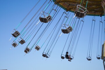Teenage girl on chain swing carousel