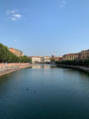 The beginning of Naviglio Grande (Darsena) canal. It is a famous local people recreation and tourists attraction place.  Park and waterfront. Milan, Lombardy, Italy