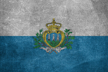 Old leather shabby background in colors of national flag. San Marino