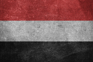 Old leather shabby background in colors of national flag. Yemen