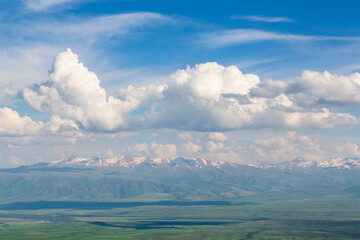 Aerial view over the valley and Talas Ala-Too and Suusamyr-Too ranges in the clouds from Ala Bel pass. Kyrgyzstan