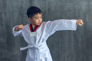 asian boy raise your fist to practice taekwondo, Taekwondo martial art