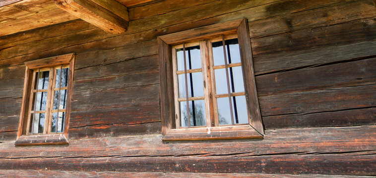 Aged wooden window with glazing and partially weathered in rustic homes