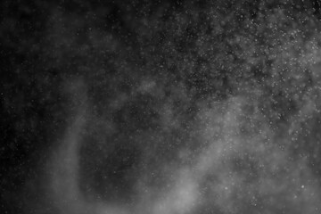 Sprayed water. Small droplets of water in the air. Lots of water drops, isolated on black background.