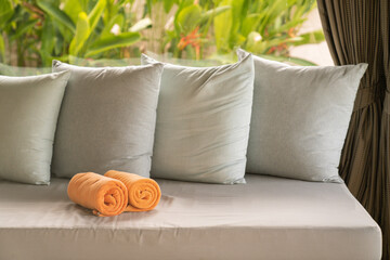 Folded orange towels decoration in stylish room interior, villa resort vacation