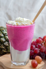 colorful healthy fresh fruit smoothy with assorted ingredients serve in glass.