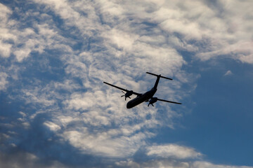 Turboprop air plane with propellers flying in the sky.