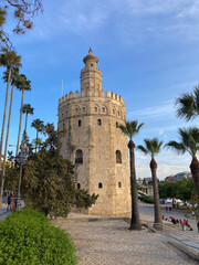 Fototapeta na wymiar Seville, Spain, September 12, 2021: The Tower of Gold at the Quidalquivir in Sevilla. The Golden Tower is one of Seville's iconic landmarks. La Torre del Oro is a military observation tower.