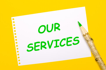 On a bright yellow background, a large wooden pencil and a white sheet of paper with the text OUR SERVICES