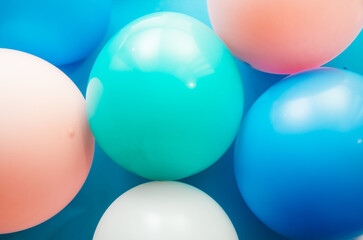 Colorful pink, green and white air balloons on vibrant blue background, design element