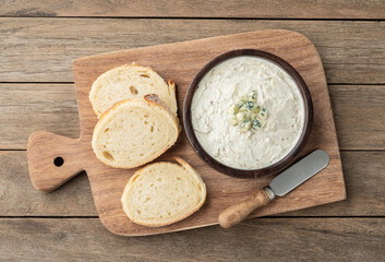 Fototapeta na wymiar Gorgonzola cheese dip with sliced bread. Blue cheese cream