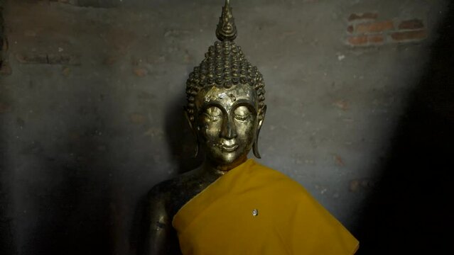 Buddha Statues Draped in Yellow at Wat Yai Chai Mongkhon in Ayutthaya, Thailand - push-back shot