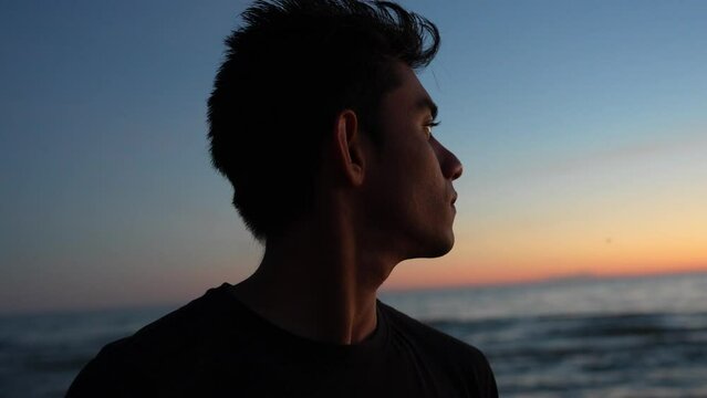Young Man, Accomplished Life Goals Looking Over the Sea at Evening