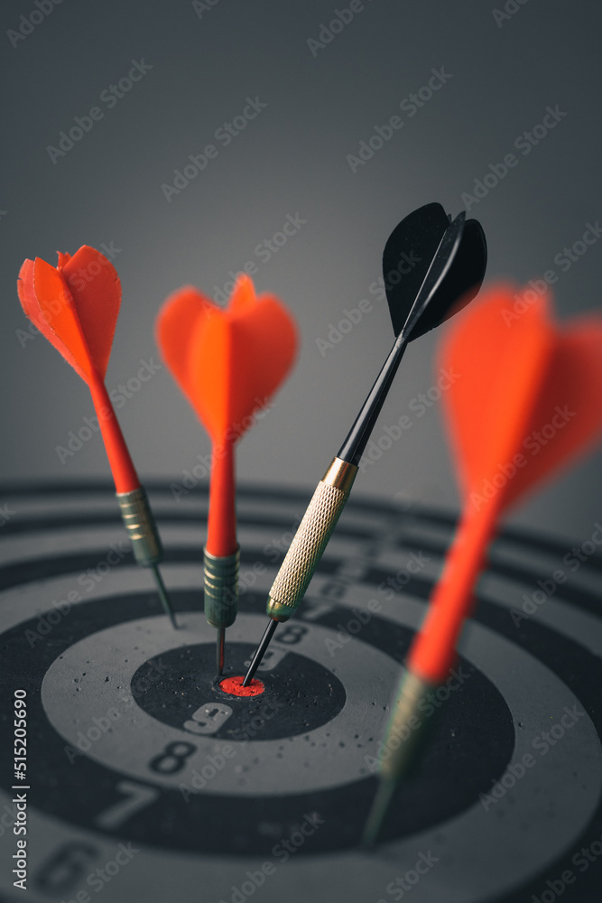 Poster close up shot of the dart arrow hit on bulleyes of dartboard to represent that the business reached 