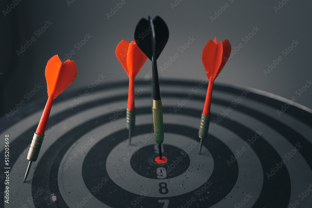 Poster close up shot of the dart arrow hit on bulleyes of dartboard to represent that the business reached 