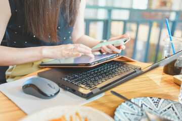 Side view of a working woman is typing on laptop computer with blank copy space screen for texting a message. Working time as concept.