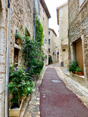 Obraz na płótnie Canvas Saint-Paul de Vence, France, October 3, 2021: Street of Saint-Paul-de-Vence, one of the oldest medieval towns on the French Riviera, is well known for its contemporary art museums and galleries.