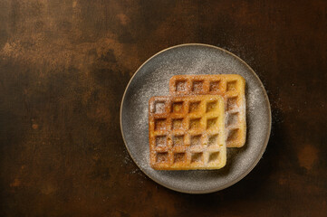 beautiful waffles on a dark background in a plate