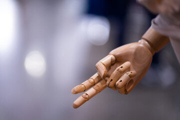 Wooden puppet hand used to display products with two thumbs up