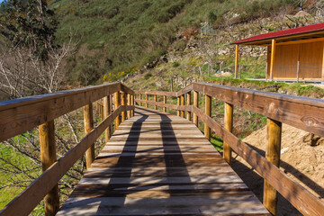 Obraz premium The river hiking trail Ecovia do Vez near Arcos de Valdevez, Portugal. Ecovia do Vez wooden pathways along the riverside.