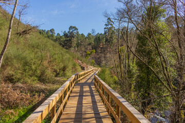 The river hiking trail Ecovia do Vez near Arcos de Valdevez, Portugal. Ecovia do Vez wooden pathways along the riverside.
