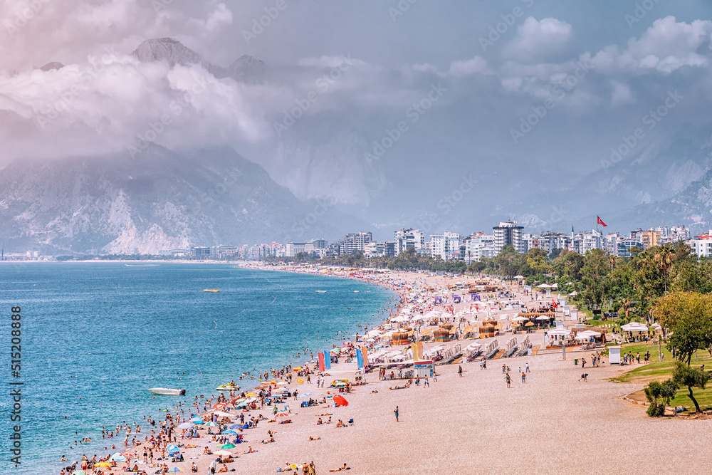 Wall mural crowded antalya city konyaalti beach with hundreds of vacationers and tourists resting, sunbathing a