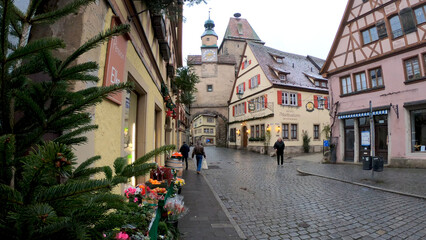 Fototapeta na wymiar Rothenburg ob der Tauber, Germany, December 8, 2021: The Marcus Tower and the Roder Arch. Markus Tower is situated nearby to Röderbogen, and close to Büttelhaus.
