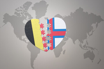 puzzle heart with the national flag of belgium and faroe islands on a world map background.Concept.
