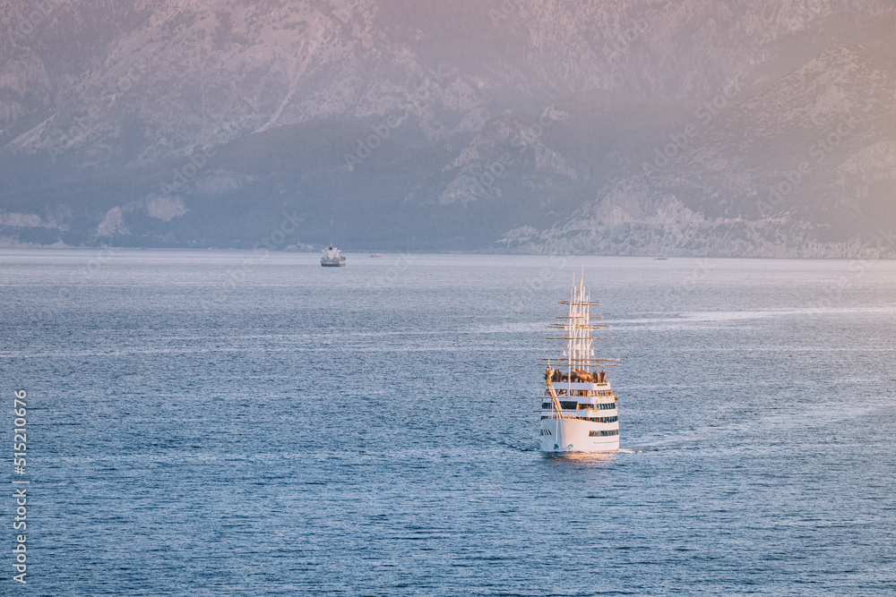 Wall mural the excursion luxury ship frigate sails on the water surface of the mediterranean sea against the ba