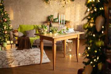 Preparing for Christmas table setting. A wooden table in a Christmas living room.