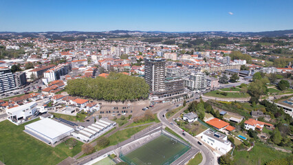 Fototapeta na wymiar Santo Tirso, Portugal - April 3, 2022: DRONE AERIAL VIEW - Apartment buildings, 25th of April Square (Portuguese: Praca 25 de Abril) and Santo Tirso City Hall.