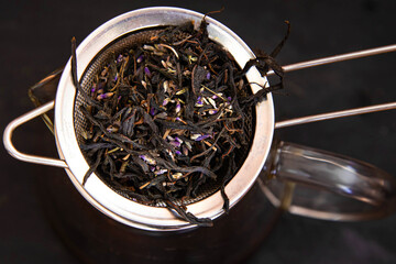 Dry leaves of black tea with lavender. Large leaf tea