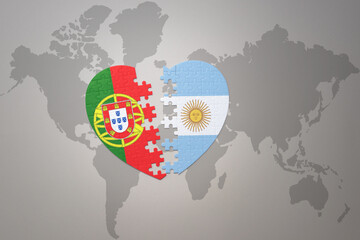 puzzle heart with the national flag of portugal and argentina on a world map background.Concept.