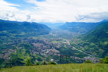 a hiking trail overlooking the alpine valley of the city Merano surrounded by the Texel group...