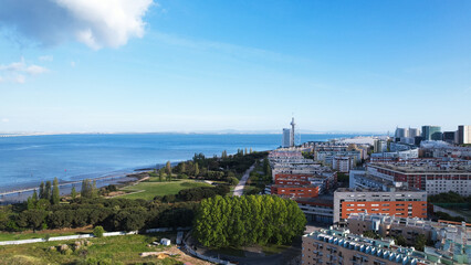 Naklejka premium Lisbon, Portugal, April 24, 2022: DRONE AERIAL SHOT - The Vasco da Gama Tower and Myriad Hotel at Park of Nations in Lisbon. Modern residential neighborhood with contemporary architecture.