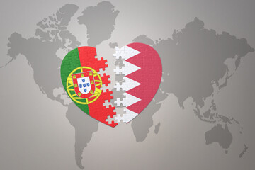 puzzle heart with the national flag of portugal and bahrain on a world map background.Concept.