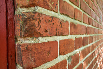 Closeup of weathered facebrick wall and copy space on exterior of a home, house or city building. Texture and detail background of rough architecture construction design of red brick on old structure