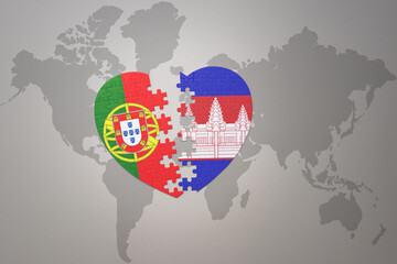puzzle heart with the national flag of portugal and cambodia on a world map background.Concept.