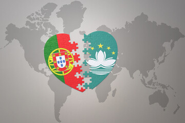 puzzle heart with the national flag of portugal and Macau on a world map background.Concept.