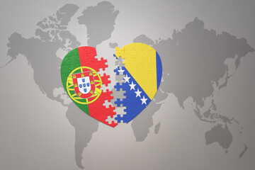 puzzle heart with the national flag of portugal and bosnia and herzegovina on a world map background.Concept.