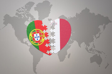 puzzle heart with the national flag of portugal and malta on a world map background.Concept.