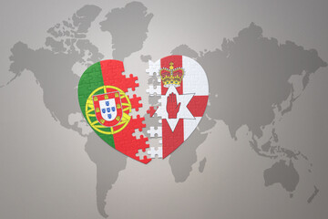 puzzle heart with the national flag of portugal and northern ireland on a world map background.Concept.