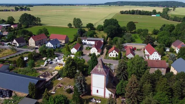 Amazing aerial view Very close passing flight drone footage of Church spire top.
at Countryside village Hainichen in Europe Saxony Anhalt, summer 2022. 4k Cinematic view from above by Philipp Marnitz