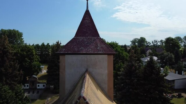 Calmer aerial view Very close passing flight drone footage of a church tower spire
at Countryside village Hainichen in Europe Saxony Anhalt, summer 2022 4k Cinematic view from above by Philipp Marnitz