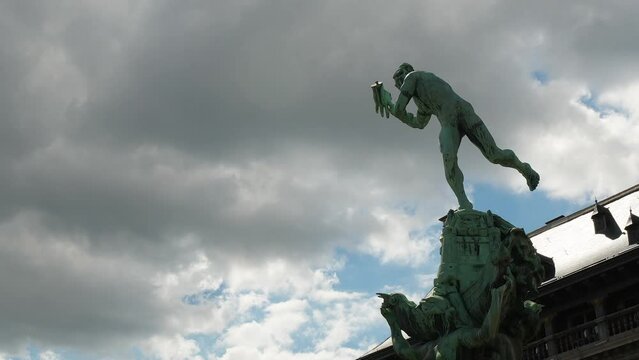 Dark Clouds Over Brabo's Monument In Front Of Antwerp City Hall In Belgium. Timelapse