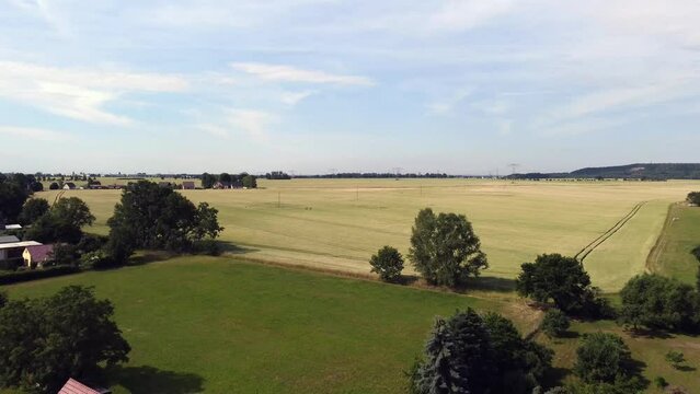 Three fields economy
Smooth aerial view flight fly backwards drone footage at Countryside village Hainichen in Europe Saxony Anhalt, summer 2022. 4k Cinematic view from above by Philipp Marnitz