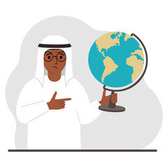 A muslim man holds a globe in his hand and points his finger at it. The concept of education, teacher, world conquest, ecology.